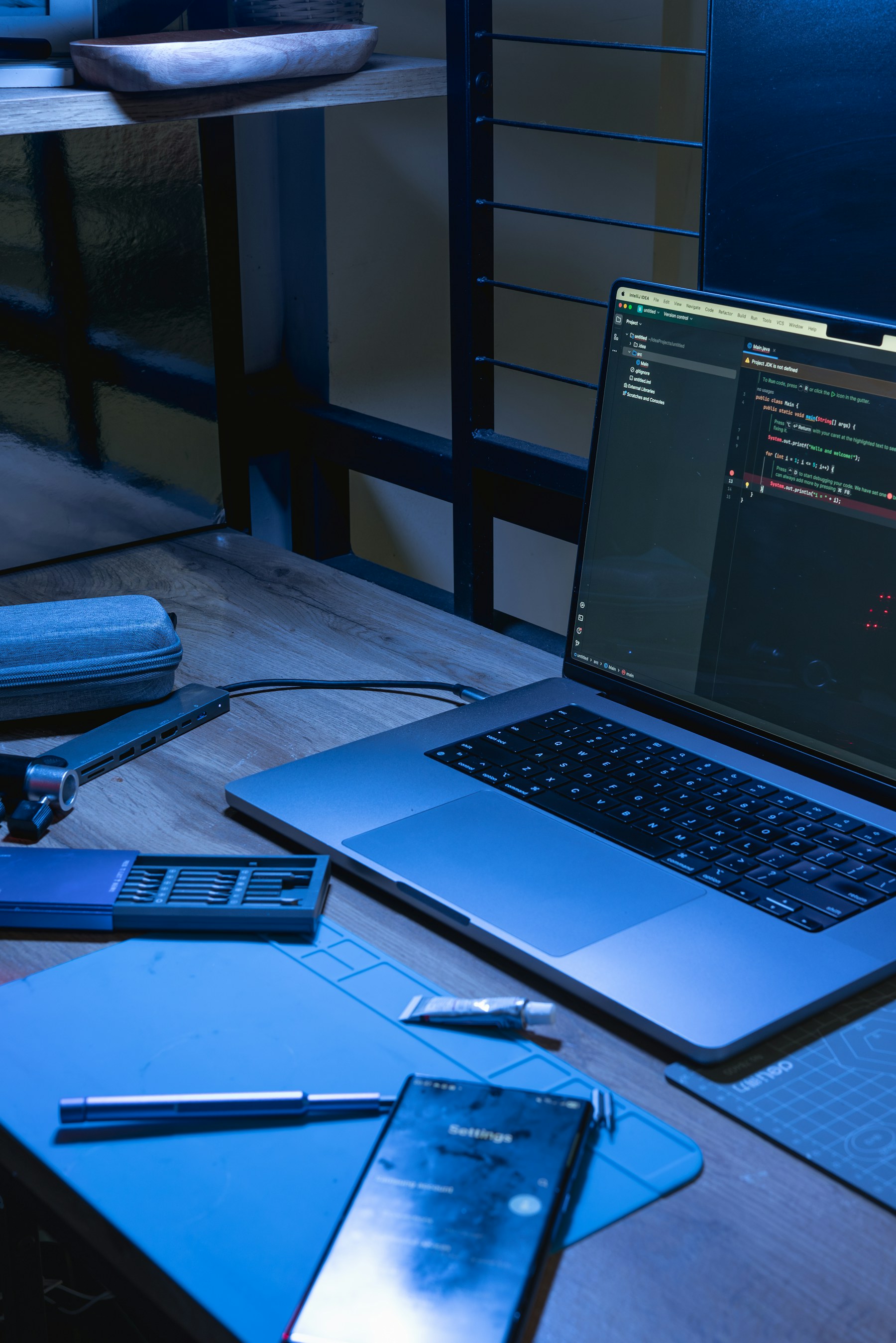 Web development workspace with a laptop displaying source code
